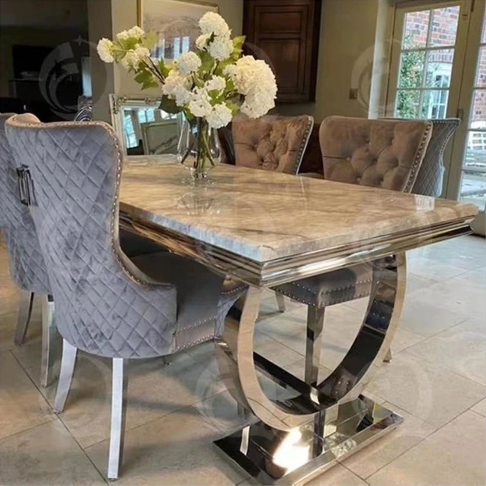 Luxury marble dining table set featuring a designer silver frame and four elegant chairs in a stylish dining room.