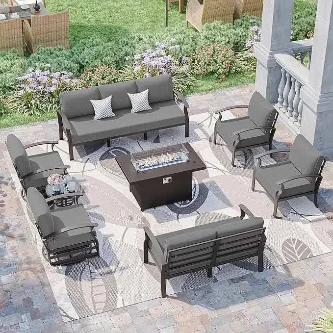 Outdoor patio furniture set with fire pit table on a stone patio