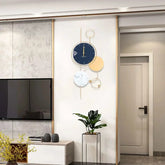 Stylish large gold metal wall clock enhancing modern living room decor with elegant design and high-quality materials.