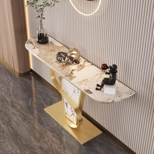 Decorative console table with marble top and gold base in a room setting.