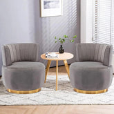 Modern swivel barrel chairs in grey velvet with gold accents, perfect for a stylish living room.