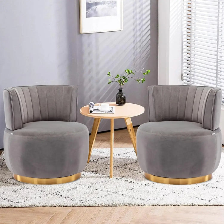 Modern swivel barrel chairs in grey velvet with gold accents, perfect for a stylish living room.