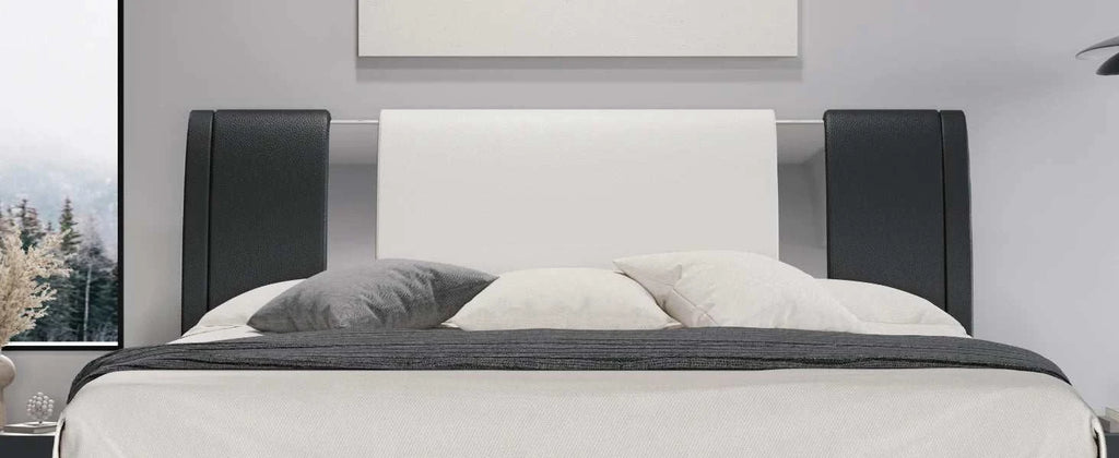 Modern bed with black and white headboard in a room setting
