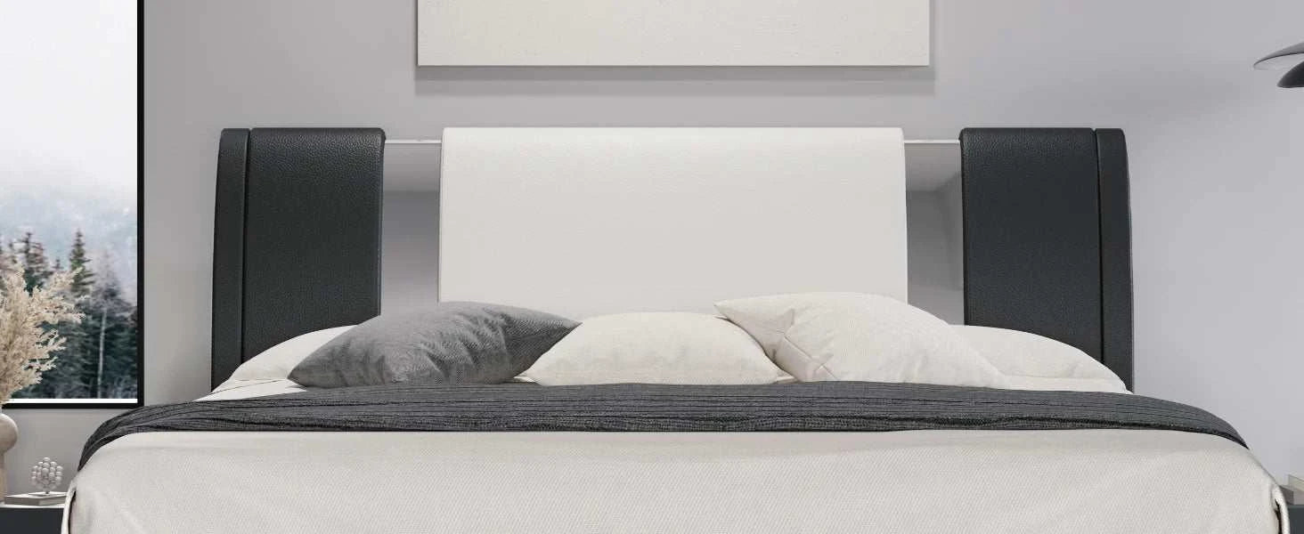 Modern bed with black and white headboard in a room setting