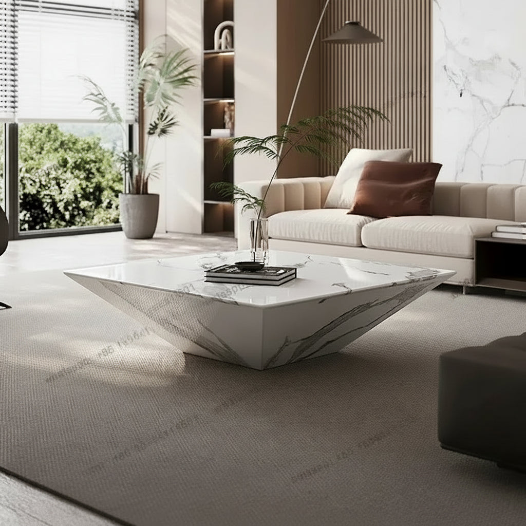 A modern living room featuring a distinctive white marble-patterned geometric coffee table on a textured beige rug, paired with a cream sofa and indoor plants.