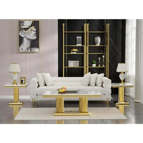 Elegant living room featuring a white faux marble coffee table set with gold accents and modern decor.