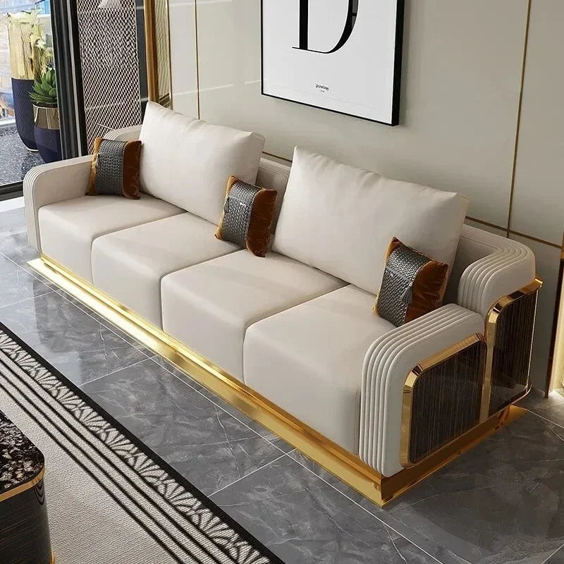 Modern white sofa with gold accents in a stylish living room.