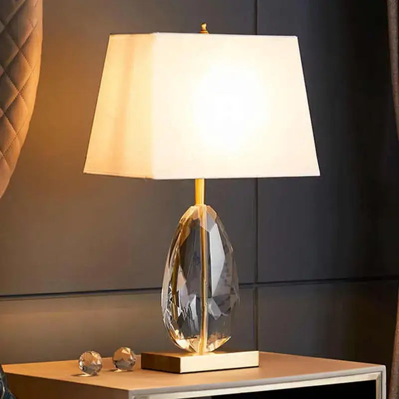 Nordic LED crystal bedside lamp with fabric lampshade illuminating a stylish nightstand.