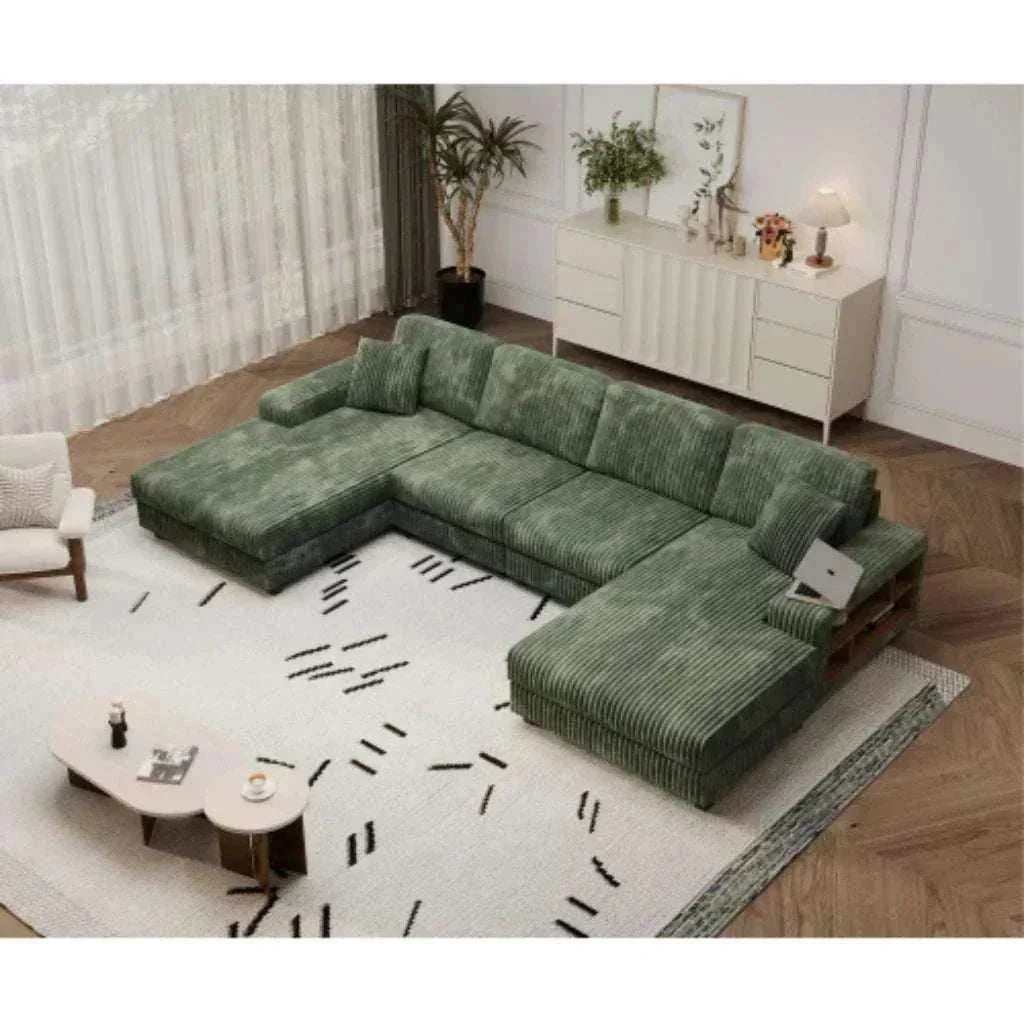 Green sectional sofa in a living room setting with a coffee table and decorative items.