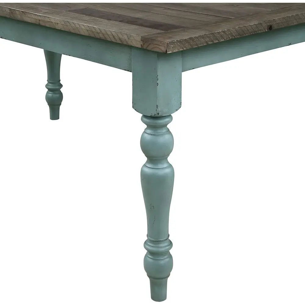 Wooden table with rustic finish and light blue painted legs on a white background