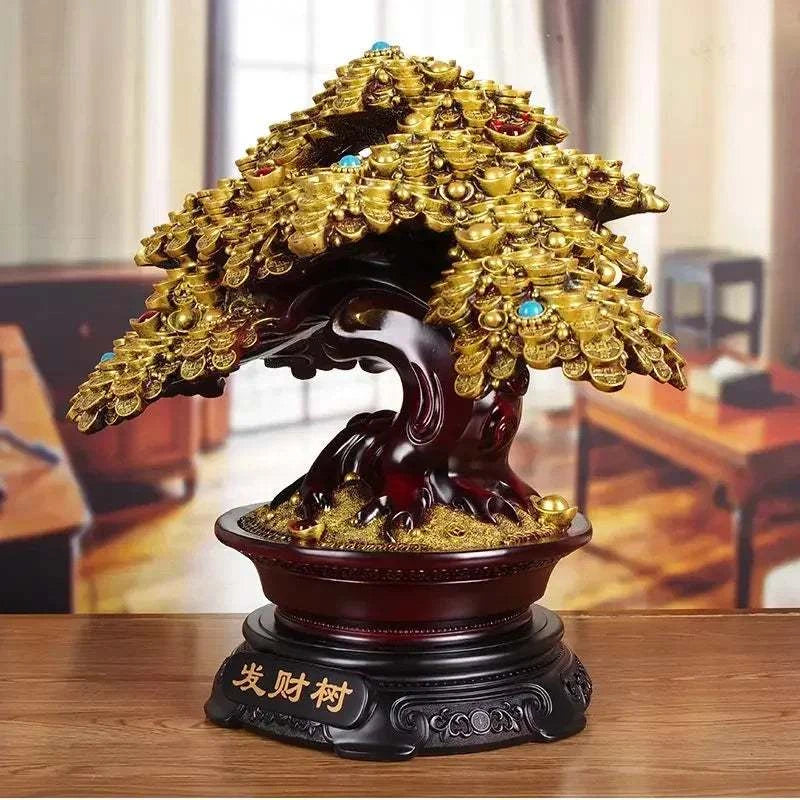 Decorative bonsai tree sculpture with gold leaves on a wooden base, set against a blurred indoor background.