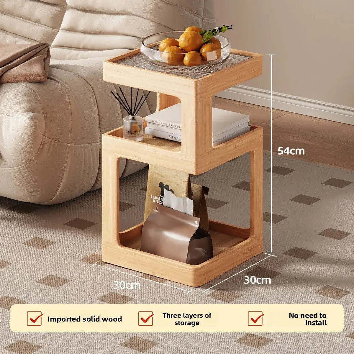 Wooden side table with storage compartments, placed on a patterned carpet next to a beige sofa.