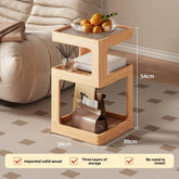Wooden side table with storage compartments, placed on a patterned carpet next to a beige sofa.