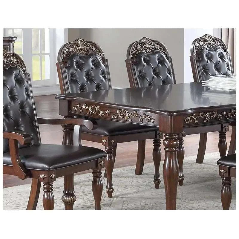 Dining table set with ornate chairs in a room setting
