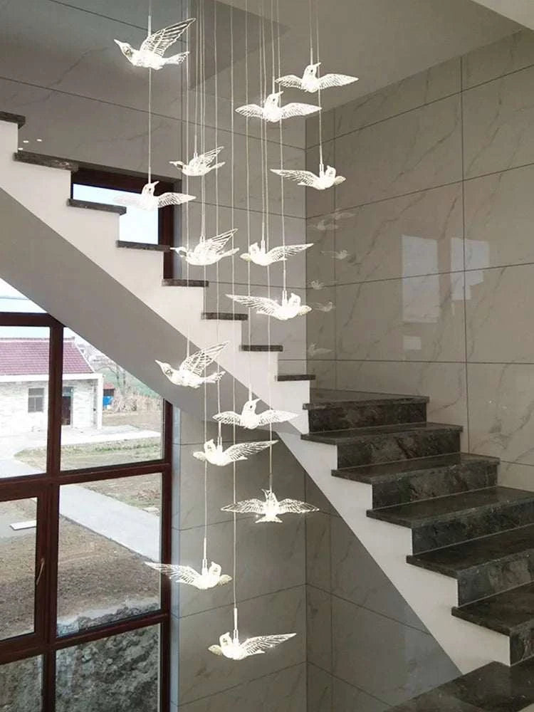Decorative hanging lights shaped like birds in a modern interior setting.