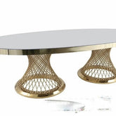 Round coffee table with gold metal base and white marble top on a white background