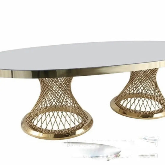 Round coffee table with gold metal base and white marble top on a white background