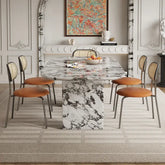 Dining room with marble table and chairs with orange cushions