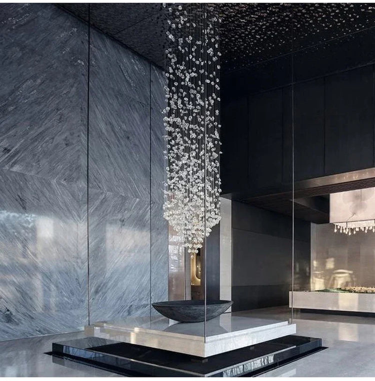 Modern interior with a decorative water feature and ceiling lights.