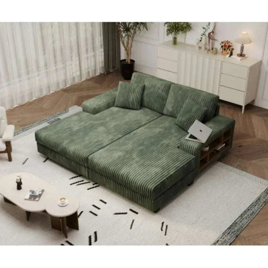 Green sectional sofa in a living room setting with a coffee table and decorative items.