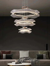 Modern led ceiling chandelier hanging over a stylish living room sofa, enhancing the elegant decor.