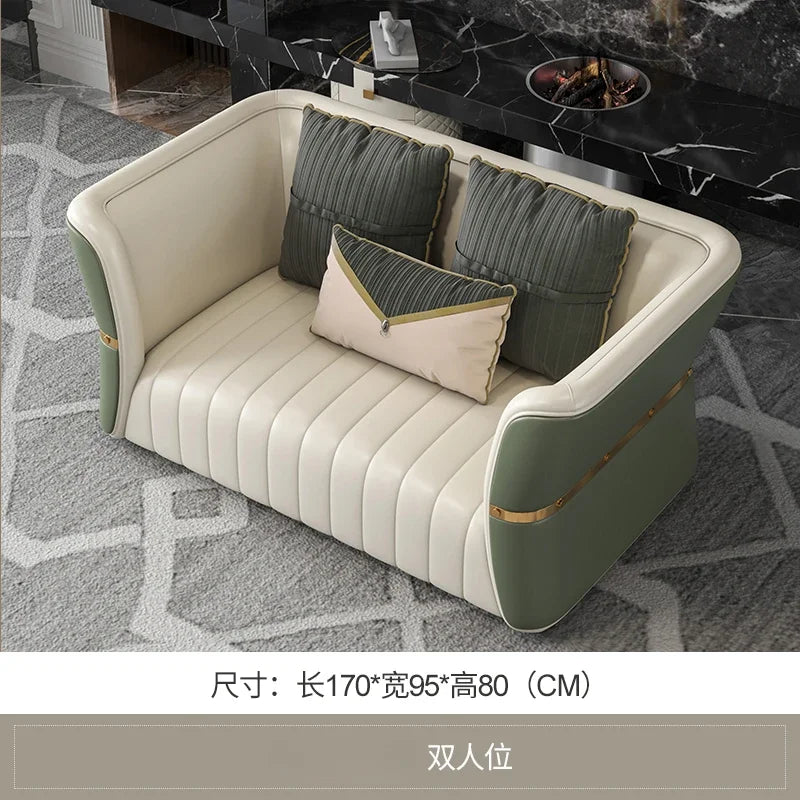 Modern sofa with green and beige cushions in a room setting.