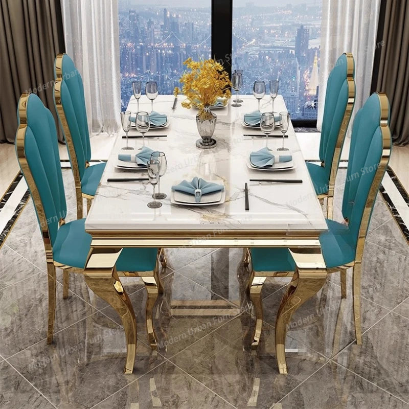 Stunning Italian rock slab dining table with chairs, featuring elegant blue upholstery and stylish gold accents.