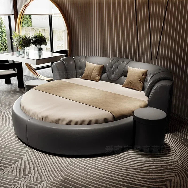 Modern round bed with gray and beige bedding in a stylish room.