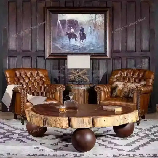 Living room with leather armchairs and a wooden coffee table, featuring a framed picture on the wall.