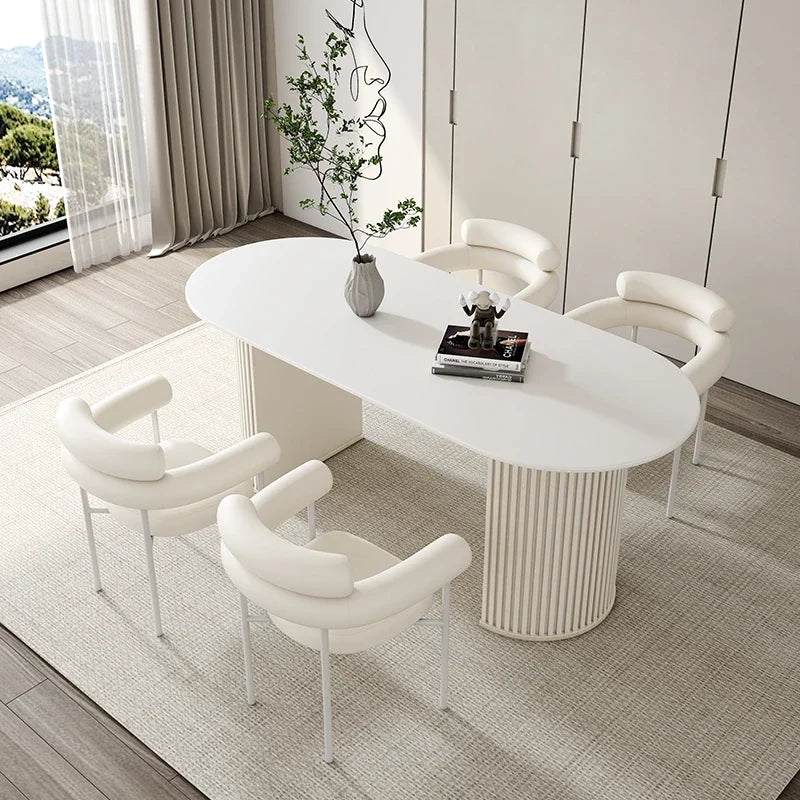 Modern white dining table with chairs in a stylish room.