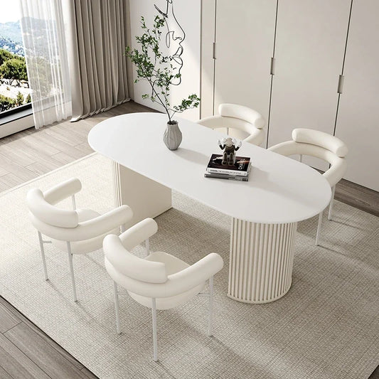Modern white dining table with chairs in a stylish room.