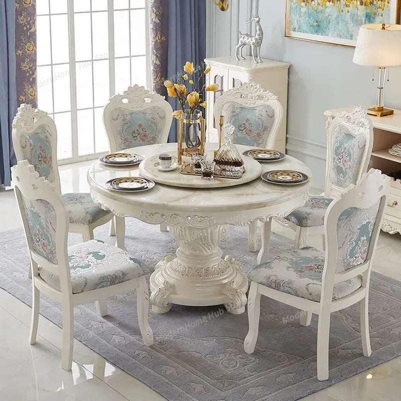 european marble round dining table with ornate white chairs in a stylish interior setting