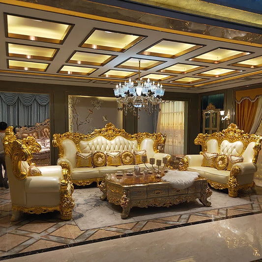 Luxurious living room with ornate gold and white furniture, chandelier, and decorative ceiling.