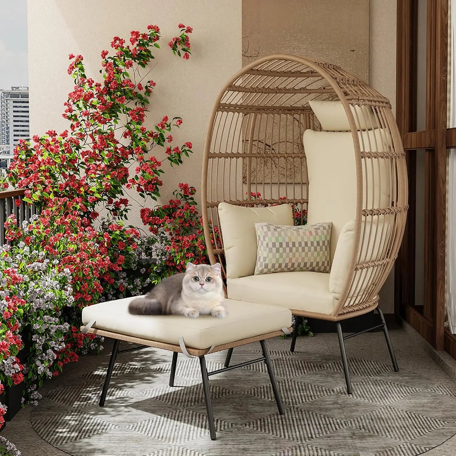 Wicker chair with cushions and a cat on a balcony with flowers