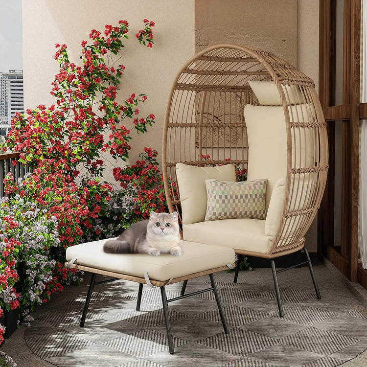 Wicker chair with cushions and a cat on a balcony with flowers