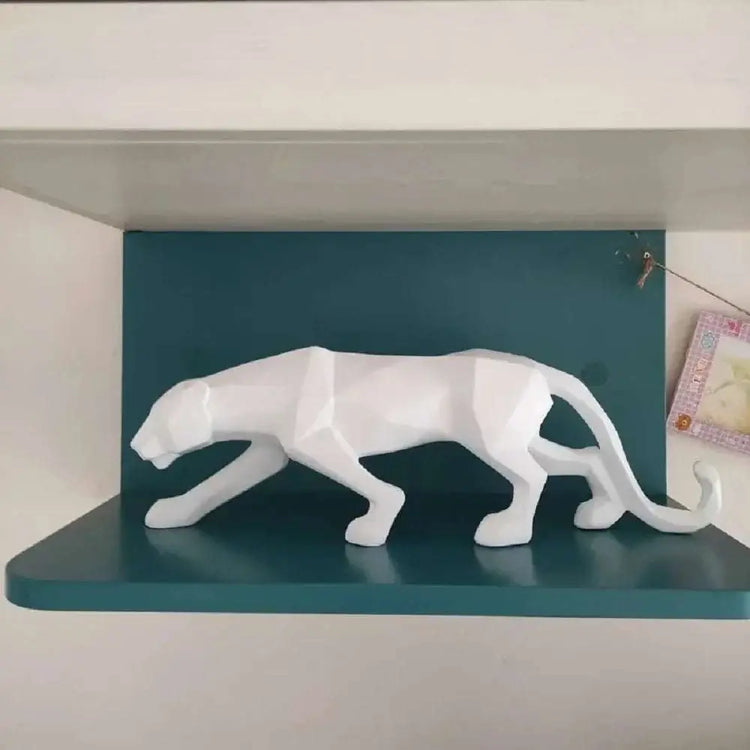 Abstract geometric panther sculpture displayed on a stylish shelf with a modern blue background.
