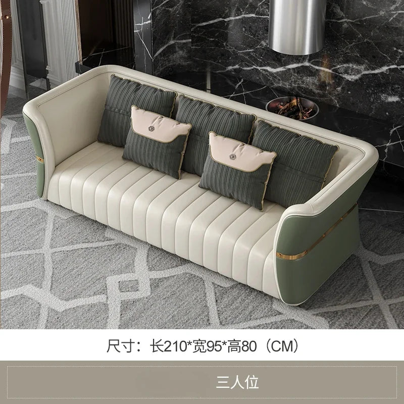 Modern sofa with decorative pillows in a stylish room with marble wall.