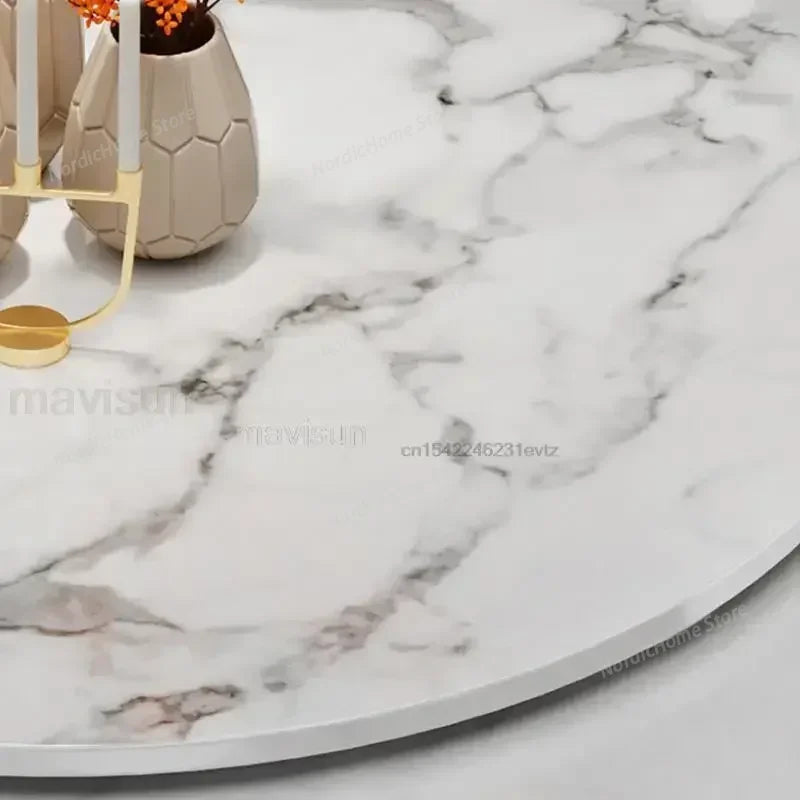 Close-up of the marble-effect top of a modern marble glass dining table with decorative vase and candle holder.