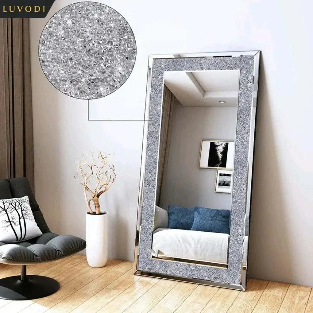 Large silver rhinestone mirror with sparkly crystal frame enhancing a modern living space.