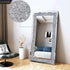 Large silver rhinestone mirror with sparkly crystal frame enhancing a modern living space.