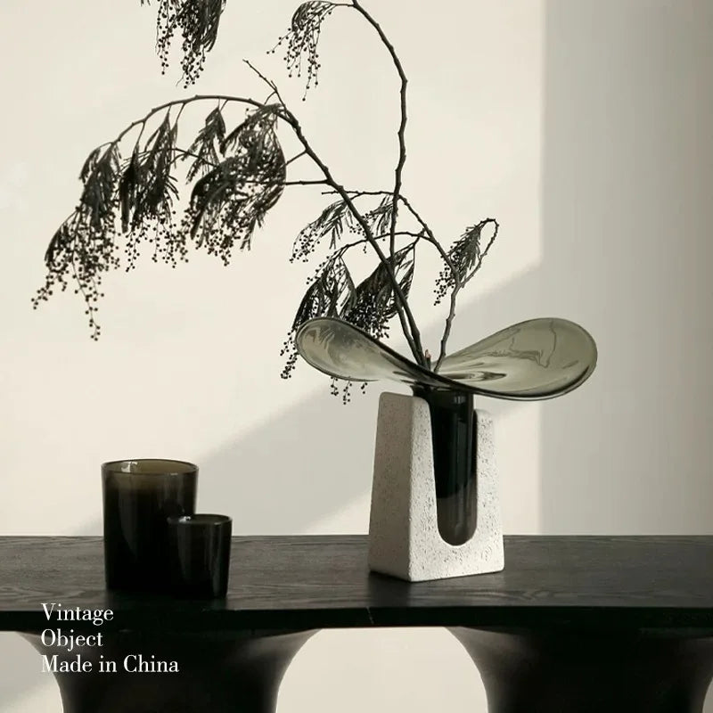 Vintage luxury glass vase showcasing its elegant design with decorative branches on a stylish table.