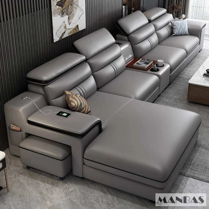 Gray sectional sofa in a living room setting with 'MANBAS' branding.