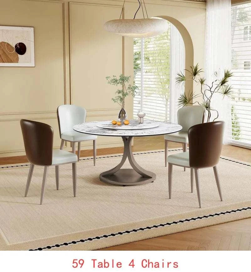 Dining room with a round table and four chairs in a well-lit room.