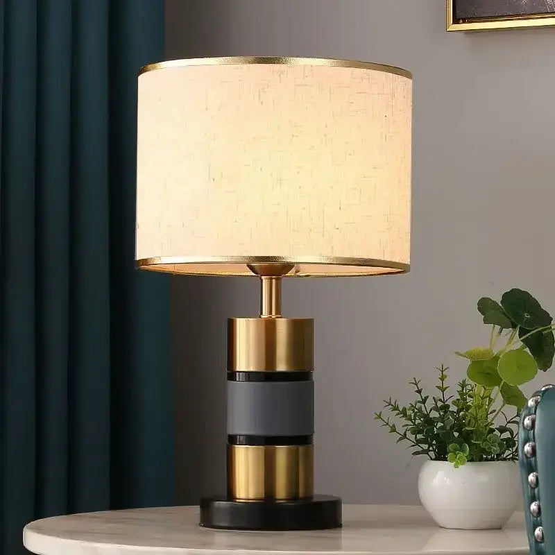 Luxury LED bedside lamp with gold frame and fabric shade on side table, enhancing modern decor.