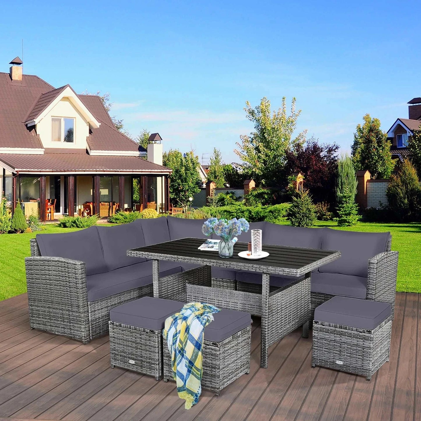 7 PCS Patio Rattan Dining Set with handwoven PE rattan, gray cushions, modular sectional design, and spacious table on wooden deck.