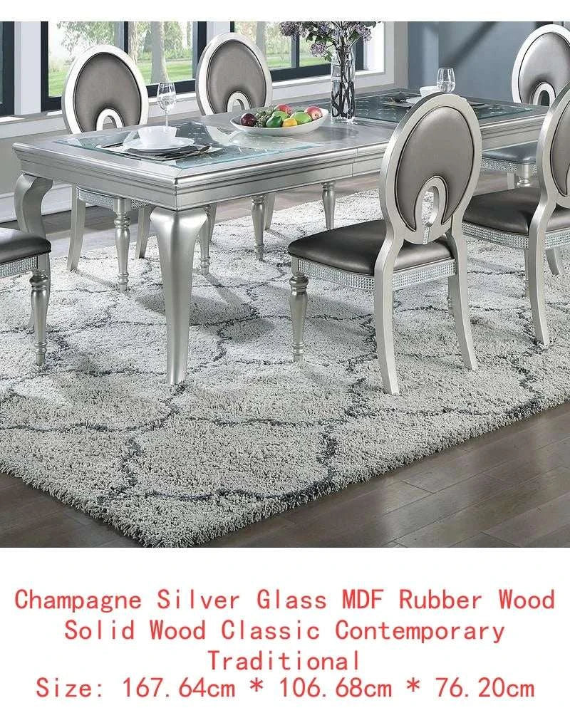 Dining table set with 6 chairs on a patterned rug in a room.