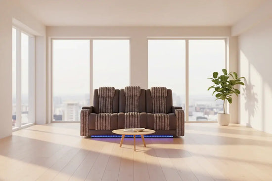 Cozy living room featuring a power reclining sofa set with LED lights, modern decor, and large windows.