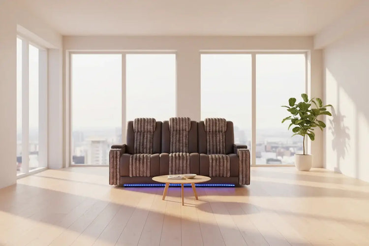 Cozy living room featuring a power reclining sofa set with LED lights, modern decor, and large windows.