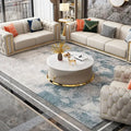 modern white leather modular sofa in a stylish living room with decorative cushions and a round coffee table