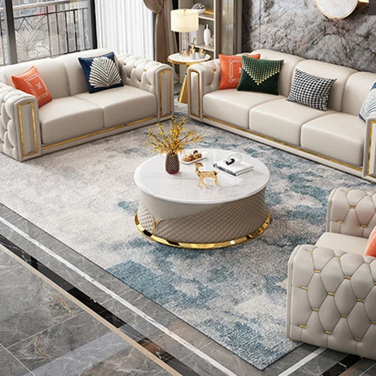 Modern living room with beige sofas, a coffee table, and decorative pillows on a patterned rug.